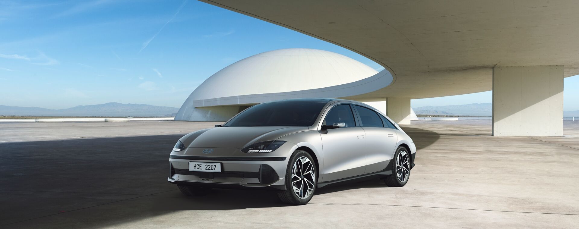 IONIQ 6 is placed in front of a building with white color